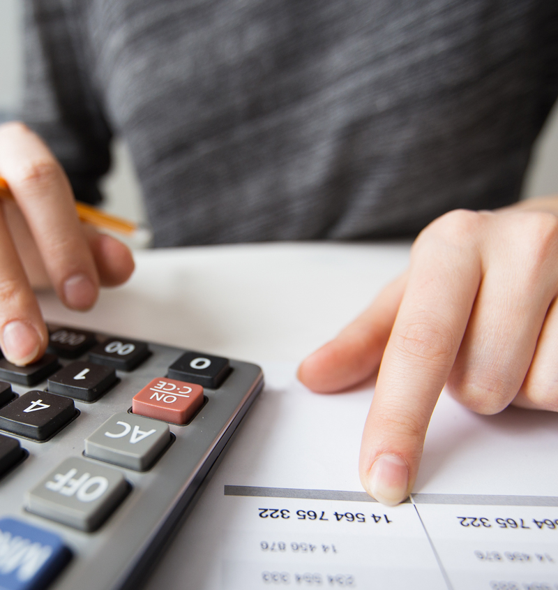 Closeup of Accountant Hands Counting on Calculator