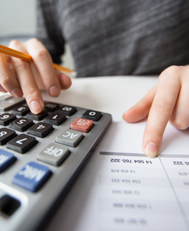 Closeup of Accountant Hands Counting on Calculator