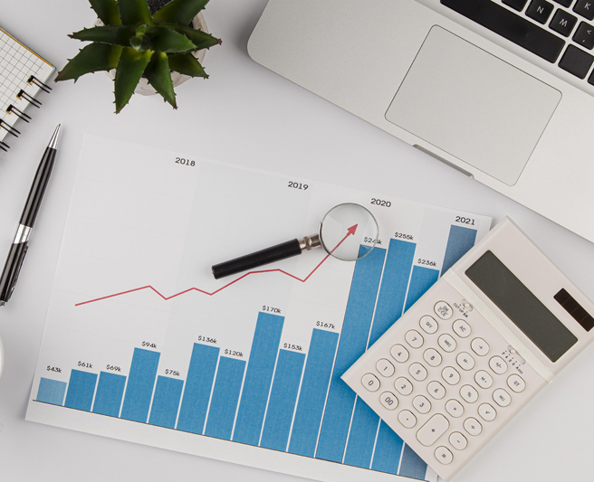 top-view-office-desk-with-growth-chart-calculator