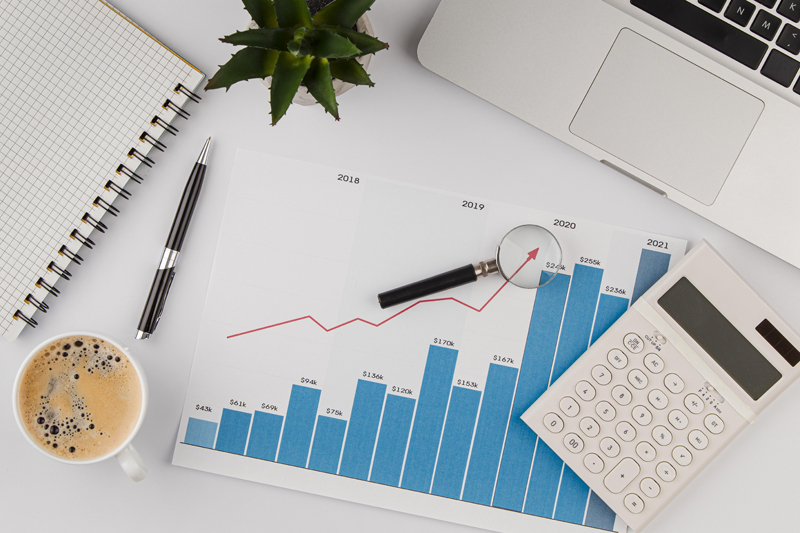 top-view-office-desk-with-growth-chart-calculator